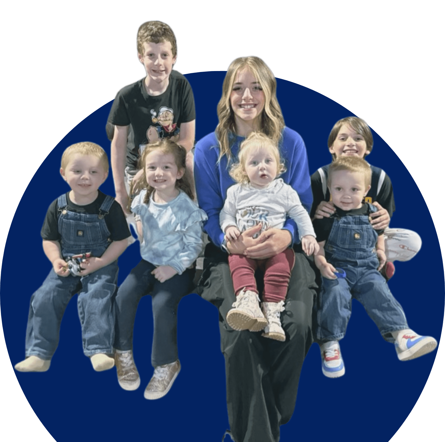 A woman and several children are posing for the camera.