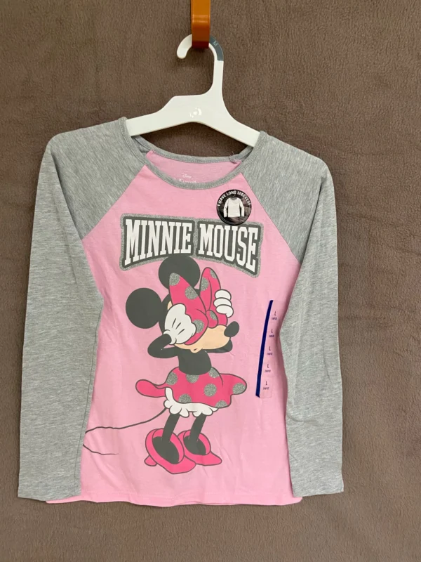 A pink and gray minnie mouse shirt hanging on a clothes rack.