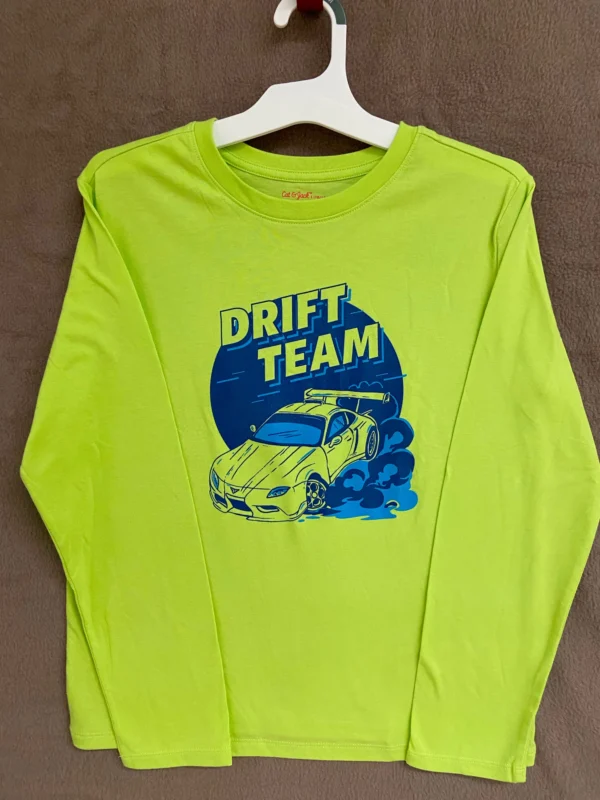 A neon green long sleeve shirt with a car on it.